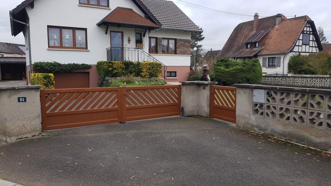 Installation coordonnée d'un portail et d'un portillon en aluminium finition bois avec barreaudage diagonal original et soubassement plein à Uttenheim.